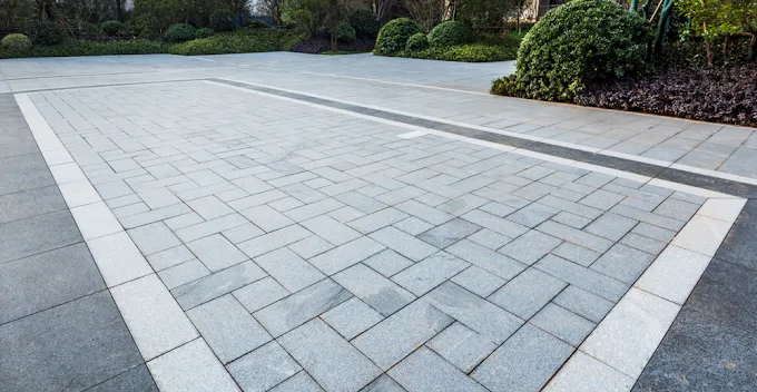 Formal grey paver plaza with a contrasting border course